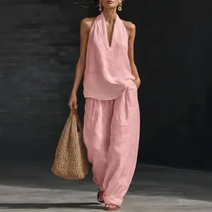 Detailed view of women's pink halter neck top and loose wide-leg trousers linen set