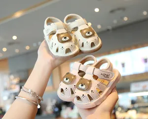 Detailed view of baby cartoon sandals with cute bear design and closed-toe protection.