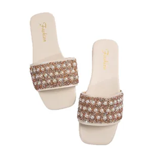 Elegant beige flat slides for women featuring pearl and rhinestone strap details