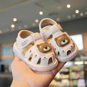 Cute pink baby walking sandals with cartoon bear design and soft non-slip sole for toddlers