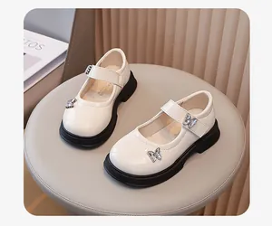 Detailansicht der cremefarbenen Mary Jane Mädchenschuhe mit glitzernden Schmetterlingsakzenten