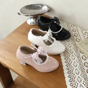 Group shot of girls' patent leather princess shoes in black, white, and pink colors.