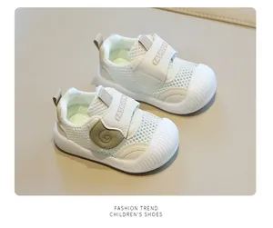 Detail of breathable white mesh baby walking shoes with rubber toe caps.