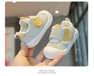 Close-up of breathable mesh baby walking shoes with cute snail design.