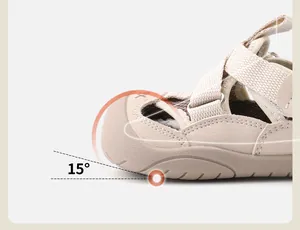 Detail view of a beige toddler sandal with a 15-degree ergonomic upturned toe design