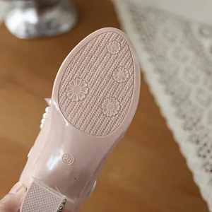 Macro view of pink children's shoe sole featuring anti-slip floral embossed patterns