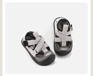 Grey and black toddler closed-toe sandals with breathable mesh and cross-strap design.