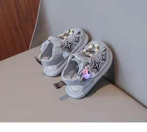 Detail view of grey LED light-up sandals for toddlers featuring a cute cartoon design