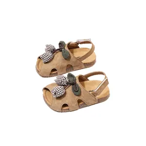 Stylish girl's brown tulip sandals with checkered flower decor for summer beach walks