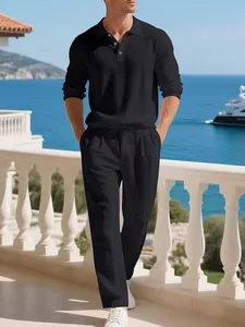 Detail shot of men's black linen long sleeve shirt and matching pants on beach balcony