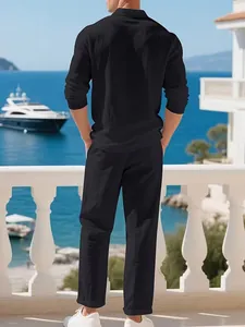 Men's black linen shirt and trousers set shown from back view in a coastal resort