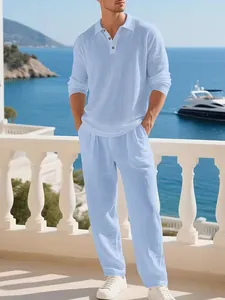 Full-body view of a men's light blue linen beach shirt and long trousers set outdoors
