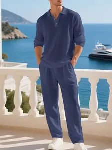 Men's navy blue linen shirt and matching trousers set displayed in a luxury resort