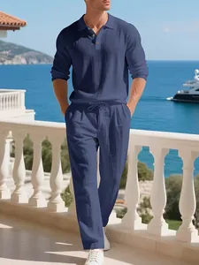 Men's relaxed blue linen-blend long-sleeve polo shirt and beach pants set on a balcony