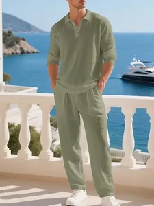 Full view of men's sage green linen polo shirt and trousers set on a coastal balcony