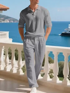 Detail view of men's breathable light grey linen long sleeve polo and beach trousers set