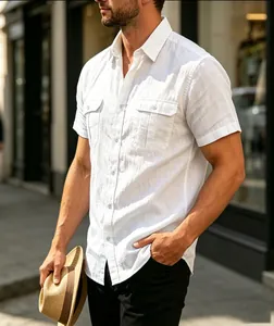 Detailed view of white linen short-sleeve button-up shirt featuring dual chest pockets.