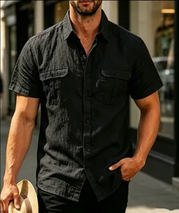 Detailed view of men's black jacquard short sleeve shirt with double chest pockets