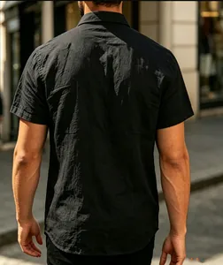 Back view of men's black short-sleeve polo shirt showing jacquard fabric texture