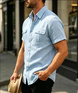 Side view detail of a men's light blue short sleeve shirt with functional chest pockets.