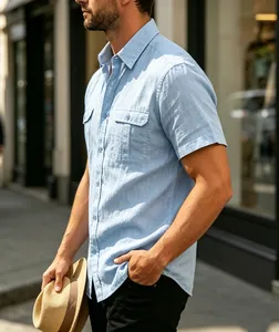 Detail showing the light blue textured fabric and chest pockets of the men's shirt