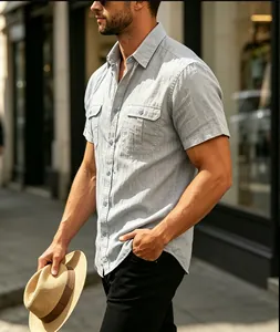 Side view of a men's light grey short-sleeved linen shirt in an urban setting