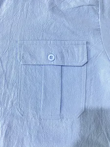 Detail shot of light blue jacquard shirt showing pocket and fabric texture