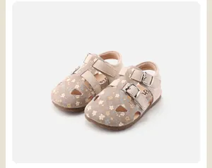 Close-up of floral hollow-out toddler sandals with adjustable double buckle straps