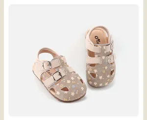 Detail view of floral baby girl sandals with hollow design and buckle straps.
