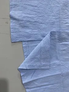 Detailed view of the fine stitching and jacquard fabric texture on blue polo shirt