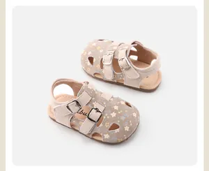 Detailed view of girls' floral hollowed-out sandals with double buckle straps