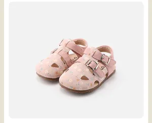 Detailed view of pink floral pattern and buckle straps on toddler girl sandals