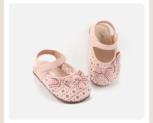 Nahaufnahme rosa Baby-Sandalen für Mädchen mit Webstruktur und Schleifen