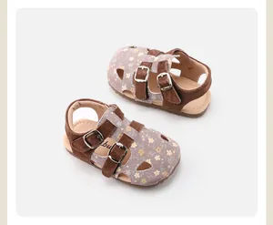 Close-up view of toddler girls' floral hollowed-out sandals with brown buckle straps