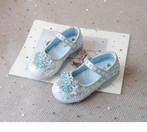 Detail view of sparkling light blue crystal princess shoes for girls with snowflakes.