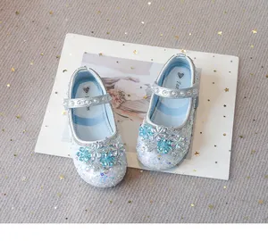 Detail view of sparkly blue and silver princess shoes with crystal flower accents