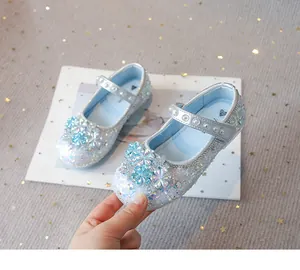 Detailed view of glittering blue princess shoes with crystal flower decorations for girls