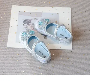 Detail of sparkling blue girls princess shoes with snowflake rhinestones and faux pearls
