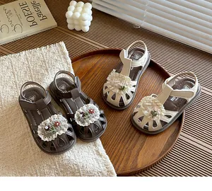 Detailed view of sweet floral closed-toe baby sandals in cream and brown shades