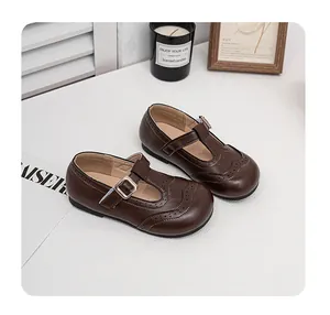Classic brown leather girls' Mary Jane shoes featuring elegant brogue wingtip details