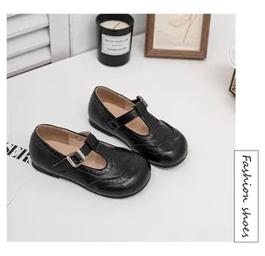 Elegant black Mary Jane shoes for girls with T-strap and perforated brogue details