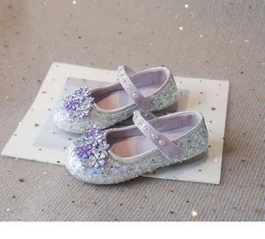 Detail view of sparkly purple girls princess shoes with rhinestones and flower accents