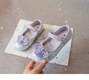 Detailed view of girls' sparkling purple Mary Jane shoes with floral rhinestone accents.