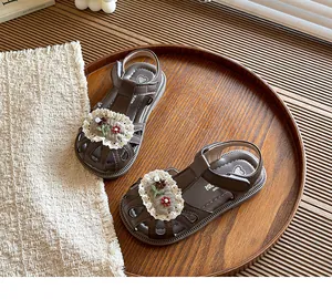 Sweet brown toddler sandals with floral embroidery and delicate lace trim detail