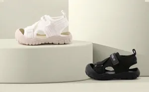 Breathable knit closed-toe children's sports sandals shown in black and white colors
