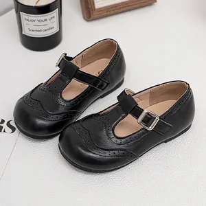 Elegant black Mary Jane shoes for girls featuring classic brogue wingtip perforation details