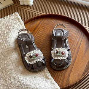 Sweet brown children's closed-toe floral sandals with soft soles and lace details