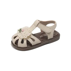 Cream closed-toe children's sandals with decorative floral lace and hook-and-loop strap