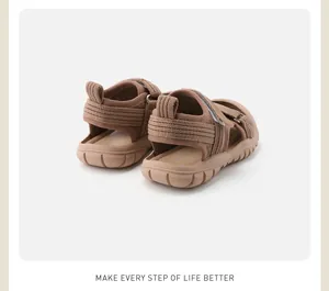 Back view of brown children's closed-toe sandals with soft soles and knit texture.