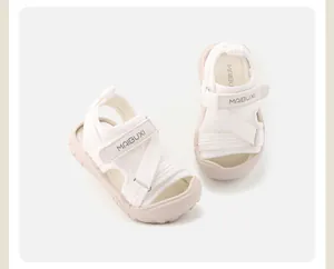 Detailed view of white children's closed-toe sandals with soft soles and straps